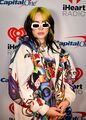 Bright multi-colored clothing became a trend in the early 2020s, as did baggier, looser-fitting clothing (in a rejection to the form-fitting 2010s fashion), as modeled here by Billie Eilish, one of the most popular musicians of the early decade.