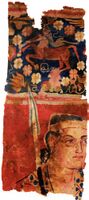 The Sampul tapestry, a woollen wall hanging from Lop County, Hotan Prefecture, Xinjiang, China, showing a possibly Greek soldier from the Greco-Bactrian kingdom (250–125 BC), with blue eyes, wielding a spear, and wearing what appears to be a diadem headband; depicted above him is a centaur, from Greek mythology, a common motif in Hellenistic art;[14] Xinjiang Region Museum.