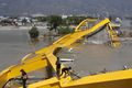 People survey the wreckage of a bridge near Talise Beach in Palu.jpg