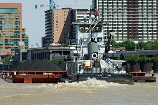 A barge hauls coal in the Louisville and Portland Canal, the only artificial portion of the Ohio River.