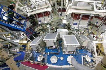 Exterior view of the upper 1/3 of the target chamber. The large square beam ports are prominent.