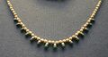 Necklace made of golden beads and pendants of jasper