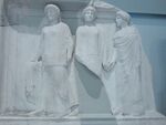 White relief of three robed Charites