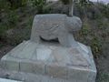 A ram grave stone embedded in concrete construction.