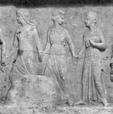 Three robed women walking