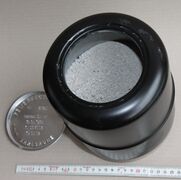 An open ash capsule showing the remains of the dead