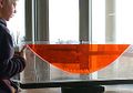 Parabolic shape formed by a liquid surface under rotation. Two liquids of different densities completely fill a narrow space between two sheets of transparent plastic. The gap between the sheets is closed at the bottom, sides and top. The whole assembly is rotating around a vertical axis passing through the centre. (See Rotating furnace)