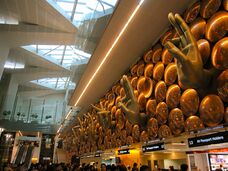 hands extending from a wall over the immigration counters