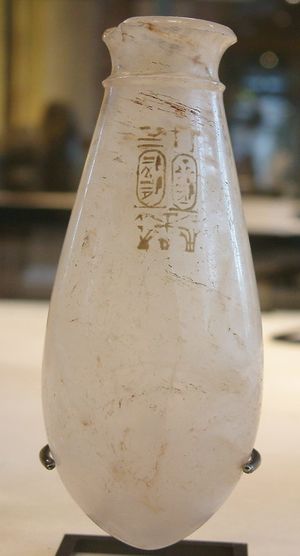 مزهرية زجاجية صغيرة عليها خرطوش رود آمون.