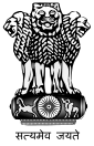 Three lions facing left, right,and toward viewer, atop a frieze containing a galloping horse, a 24-spoke wheel, and an elephant. Underneath is a motto "सत्यमेव जयते".