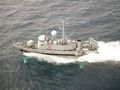 USS Aquila, a military hydrofoil. The T-shaped foils are visible just below the water.