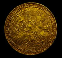 A C-type bracteate (DR BR42) featuring a figure above a horse flanked by a bird