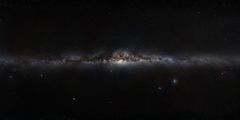 The plane of the Milky Way galaxy, which we see edge-on from our perspective on Earth, cuts a luminous swath across the image.