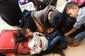 Survivors rest outside the airport as they wait for a flight out of Palu on October 1.jpg