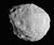 An irregular body, whose outline looks like an approximate circle in this image. It is illuminated from the bottom-left. The terminator runs from the top-left to bottom-right. The surface is covered by craters.