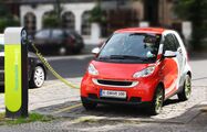 Electric vehicles became more popular for sustainable transport in the 2020s. Pictured is a vehicle being charged at a charging station, using battery power instead of gasoline.