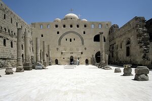 Ancient monastery complex showing massive stone walls and architectural elements reminiscent of Egyptian temple design