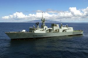 A large grey warship steaming at sea