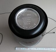 A sealed cinerary urn, showing the ash capsule containing the remains of the dead, along with the name and dates