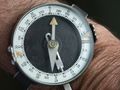 Wrist compass of the Soviet Army with dual graduations — 60° (like a watch) and 360° (below the figures for 15°, 30° and 45° of the outer graduation are the Cyrillic letters "З" (zapad = west), "Ю"(yug = south) and "В" (vostok = east)
