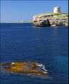 Martello tower, Alcaufar with Illa de l'aire lighthouse in the distance.