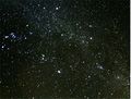 The brightest meteor, a fireball, leaves a persistent smoky trail drifting in high-altitude winds, which is seen on the right side of the image.