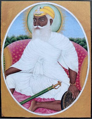 A color portrait of a bearded and turbaned man wearing white clothes and seated on a throne