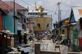 A ship that was swept ashore during the tsunami rests near houses in Donggala on October 2.jpg