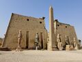 Entrance of the Luxor Temple, western façade; a pair of obelisks usually stood in front of a pylon; the 2nd obelisk (the Luxor Obelisk, 23 metres (75 ft) high, not shown) was moved in the 1830s to the Place de la Concorde in France.