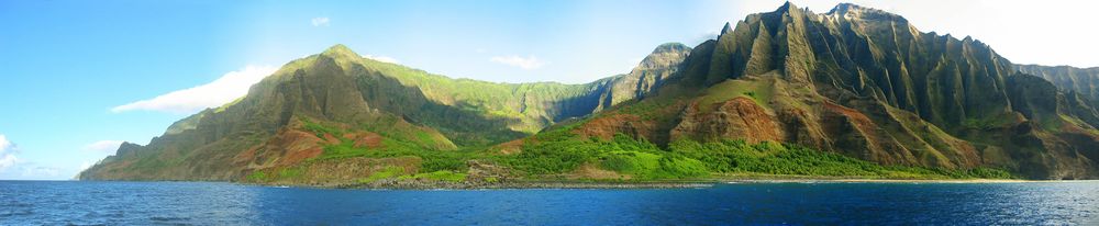 view of the Nā Pali coastline from the ocean. It is part of the Nā Pali Coast State Park which encompasses 6،175 acre (20 km2) of land and is located on the northwest side of Kauaʻii.