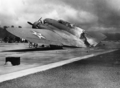 A burned B-17C aircraft rests near Hangar Number Five, Hickam Field