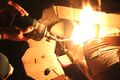 Fire starting with a torch. Wood and cardboard are used as tinder