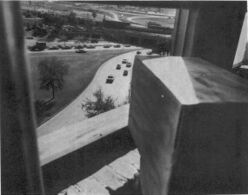 A view through a window to Elm Street, Dealey Plaza, from the shooter's location in the Depository to kill Kennedy, the so-called "sniper's nest".