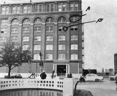 A photograph of the Texas School Book Depository, showing its view from a witness of John F. Kennedy's assassination. The window from the sixth floor is marked A, and another window from the fifth floor marked B.