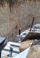 A Hasidic Jew supervising a construction site in Israel, where Hasidic groups differ over involvement in politics and society