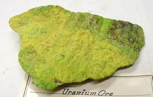 Block of yellow-green stone with rough surface.