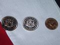 Sealandic coins, from left to right: Cupronickel Half Dollar, Silver One Dollar and Bronze Quarter Dollar