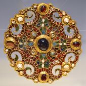 The Dorestad Brooch, c. 800, found in the Netherlands. Gold, pearls, with cloisonné almandine, enamel, and glass.