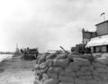 Sandbagged .30 caliber machine gun emplacement with gun crew on alert.
