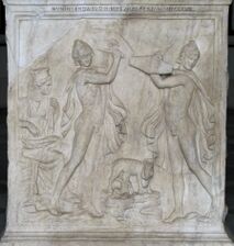 Infant Zeus is suckled, and two men hold shields